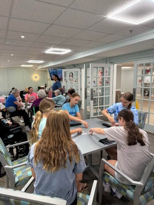 Residents and staff engaged in an activity in a common area