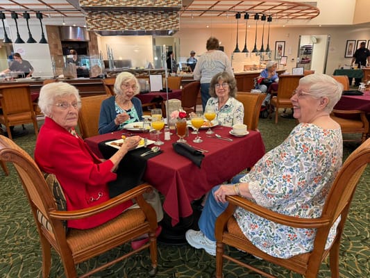 Residents enjoying a meal together in the dining room