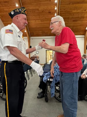 Residents celebrating an event with a veteran