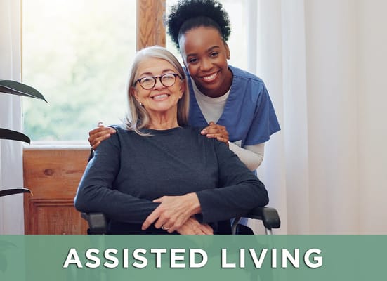 A caregiver smiling with a resident in a bright room