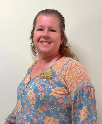 Staff member posing for a photo in an indoor setting