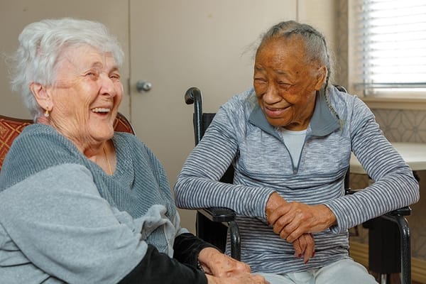 Two residents enjoying a moment together in a common area