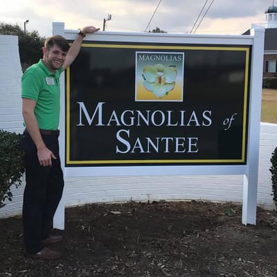 Sign of Magnolias of Santee with staff member