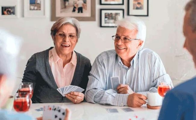 Residents enjoying a card game in a cozy setting