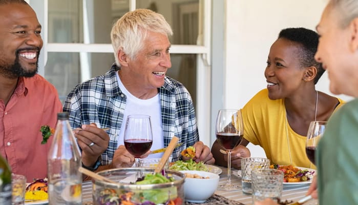 Residents enjoying a meal together at a dining table