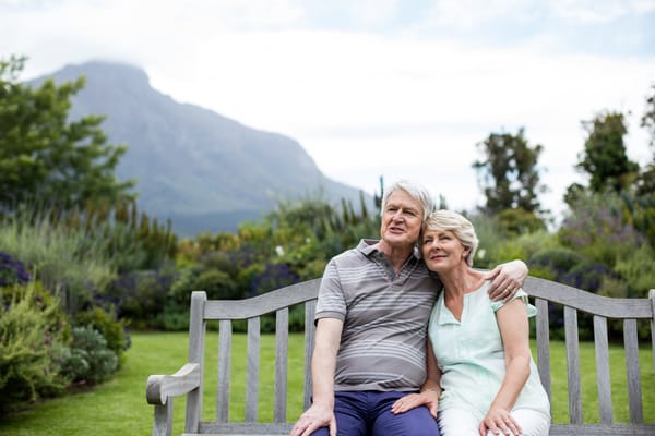 Couple sitting on a bench in a garden