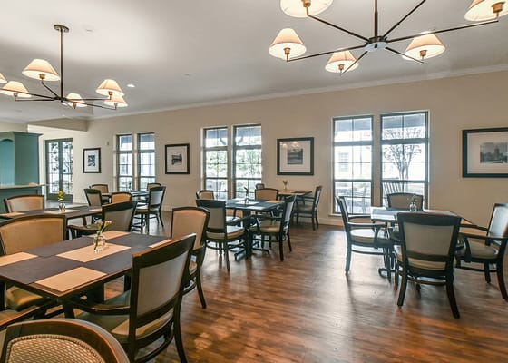 Dining area with tables and chairs, bright lighting