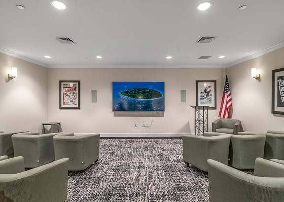 Common area with seating and a screen for movie nights