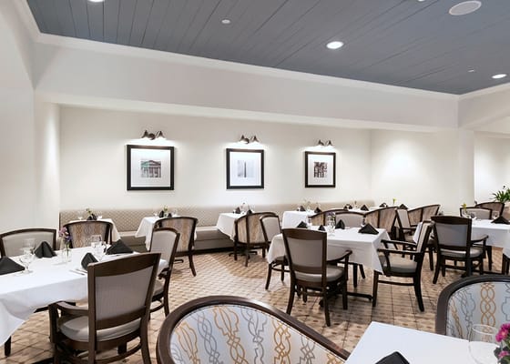 Interior view of a dining room with tables and chairs.