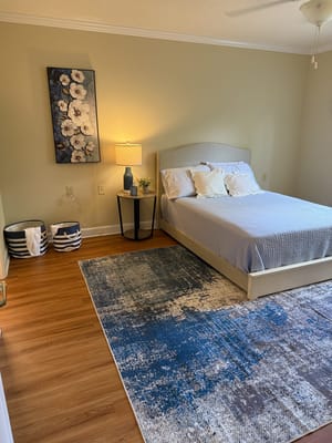 Brightly lit private resident room with a bed and decor