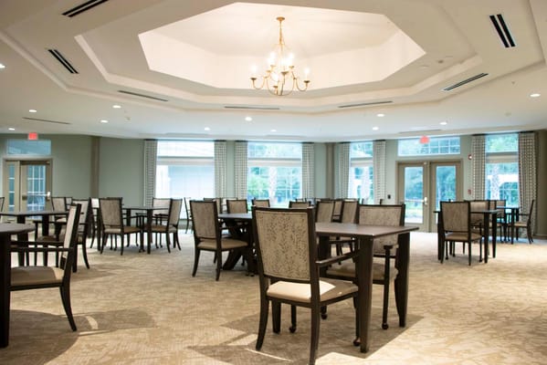 Interior view of a spacious dining room with tables and chairs