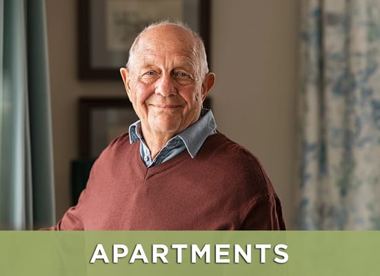 A senior man smiling in a cozy apartment setting