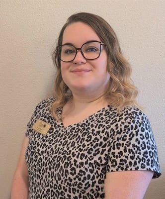 Staff member posing for a portrait in the facility