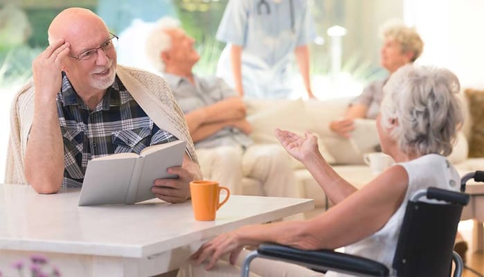 Residents engaging in conversation in a bright lounge area