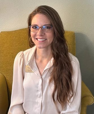Staff member smiling in a cozy living area