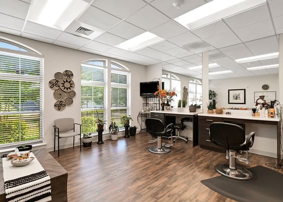Hair salon area with styling chairs and natural light