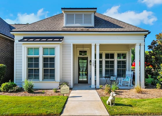 Exterior view of a senior living facility with garden