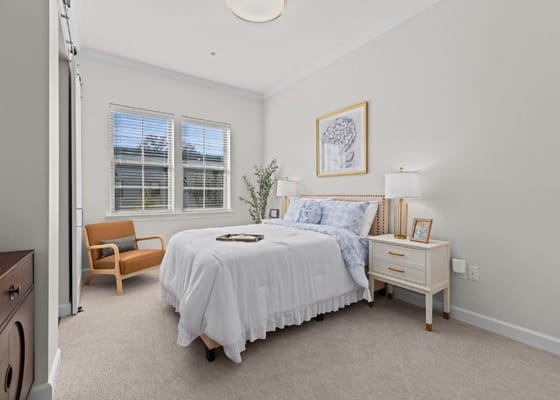 Brightly decorated resident room with a bed and window