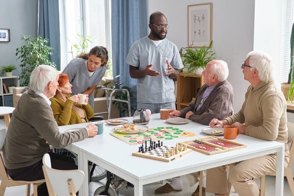 Residents and staff engaged in a board game activity