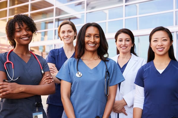 Group of healthcare professionals smiling at the facility