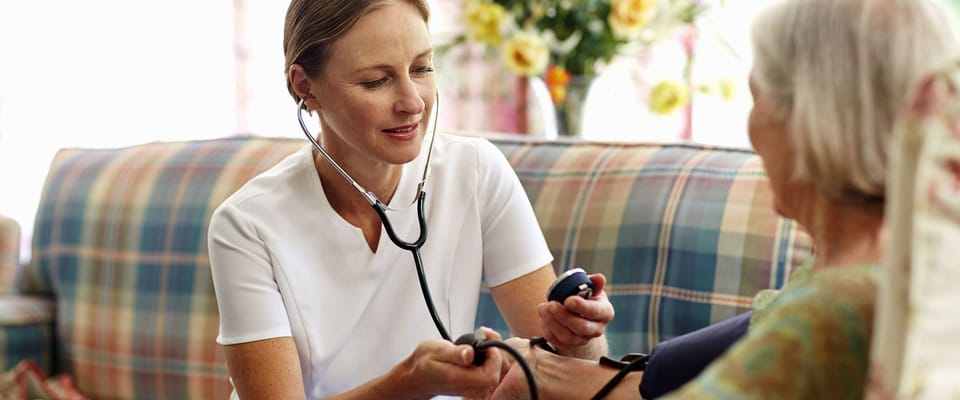 Healthcare professional attending to a senior resident