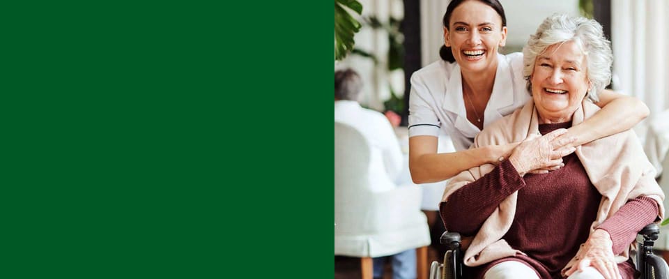 Caregiver and resident smiling in a common area
