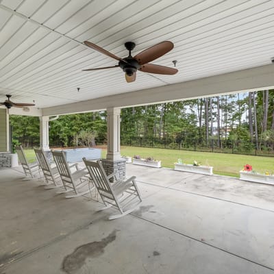 Covered outdoor seating area with rocking chairs