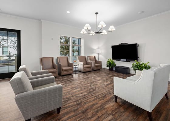 Bright common area with seating and a TV
