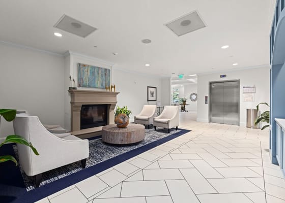 Bright lobby area with seating and an elevator