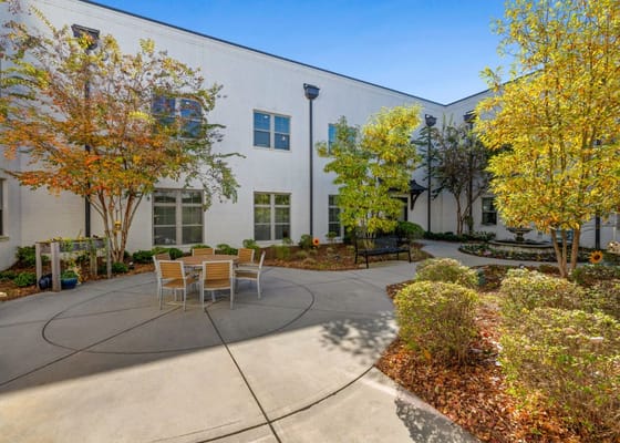 Outdoor courtyard with seating and autumn foliage