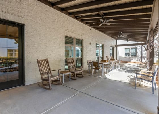 Outdoor seating area with rocking chairs and tables
