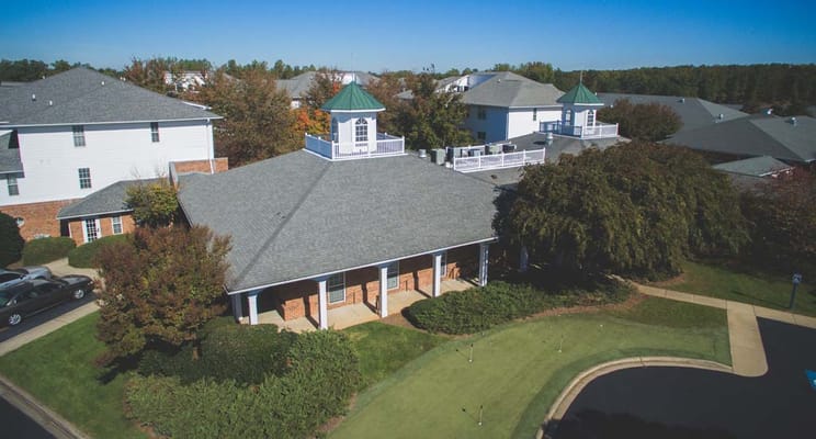Aerial view of a senior living building with a garden