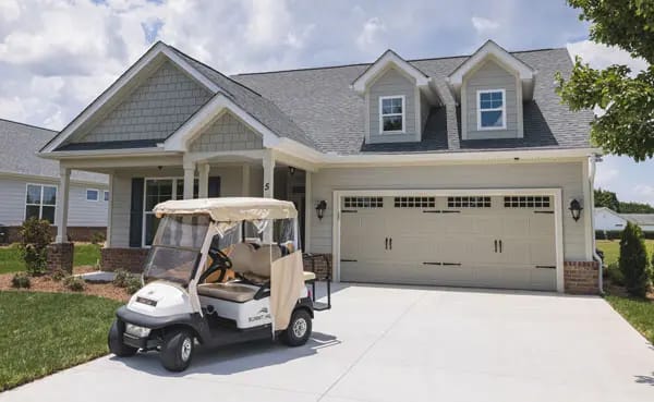 Exterior view of a residential facility with a golf cart