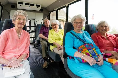 Residents enjoying transportation in a facility bus