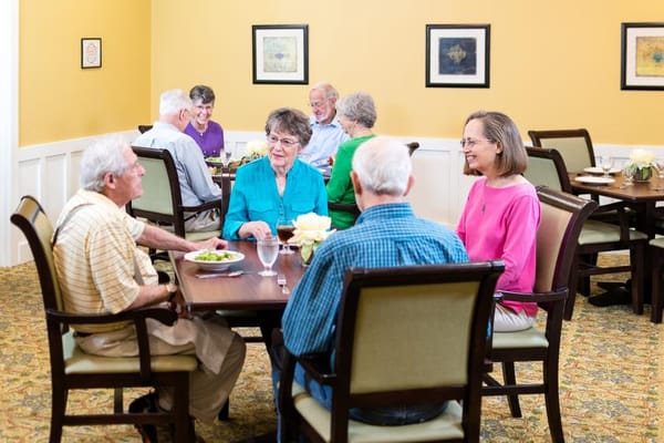 Residents enjoying a meal together in the dining room