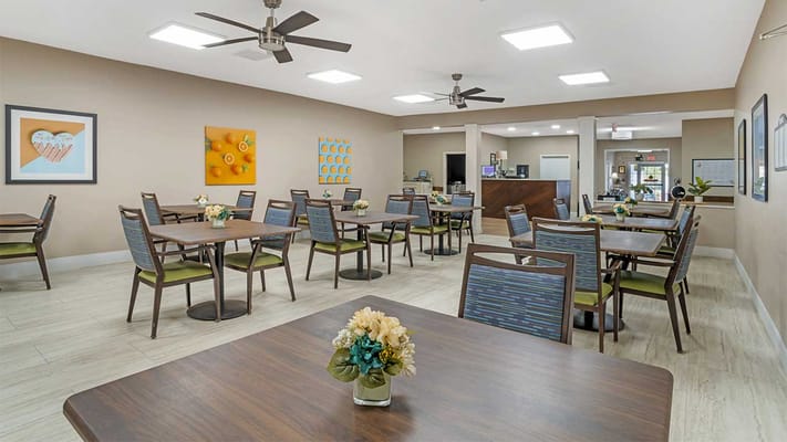 Bright dining room with tables and flowers