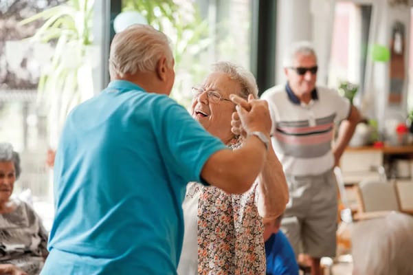 Residents enjoying a joyful dance in an activity room