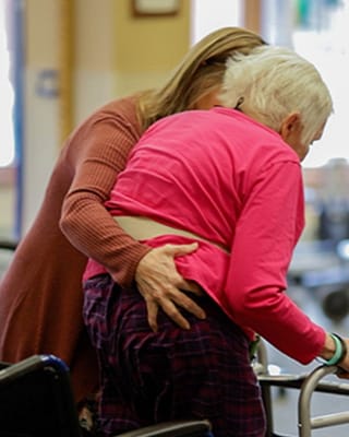 Staff assisting a resident in a warm atmosphere