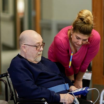 Staff assisting a resident in a common area