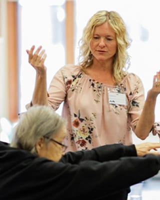 Staff member interacting with a resident in an activity room