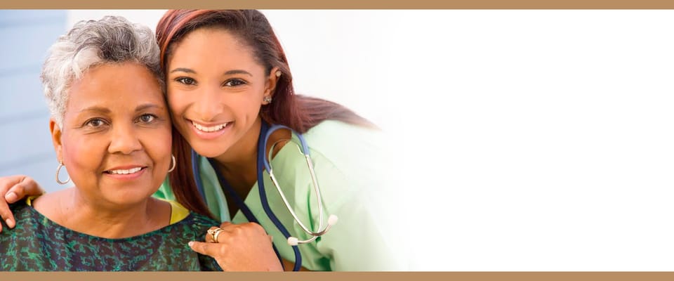 A caregiver and a resident smiling together