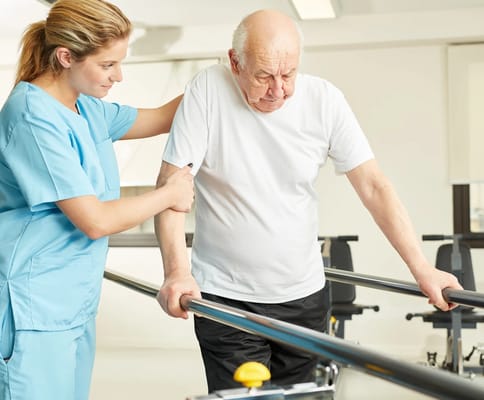 Staff assisting a resident with therapy exercise