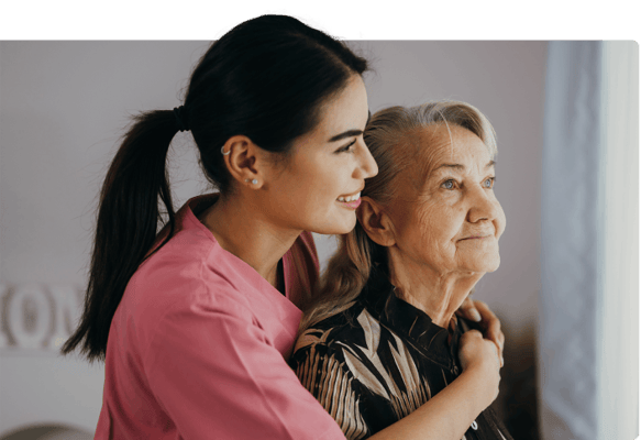 Care staff assisting a resident in a warm setting