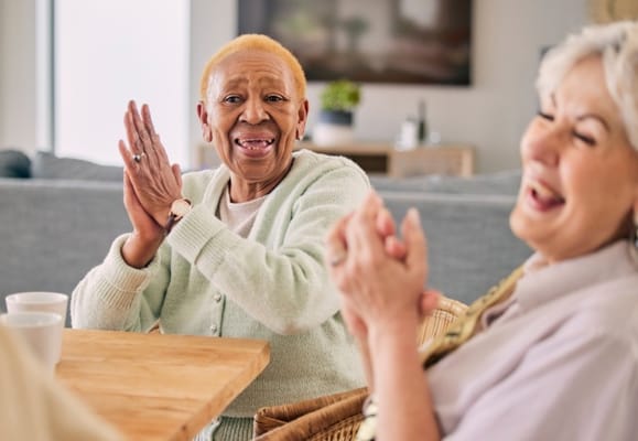 Two seniors enjoying a moment together in a common area