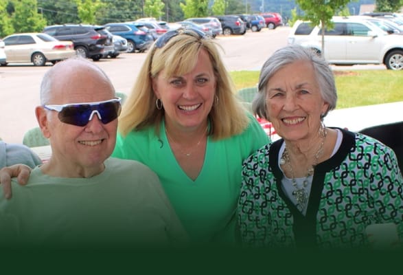 Residents enjoying an outdoor event with staff