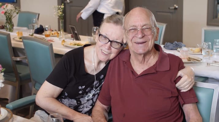 Two residents enjoying a meal together in the dining room