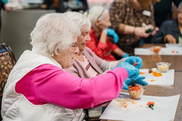 Residents engaged in an activity session with food preparation