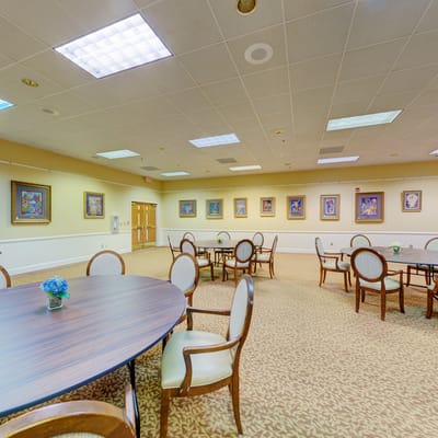 Interior of a common area with tables and artwork