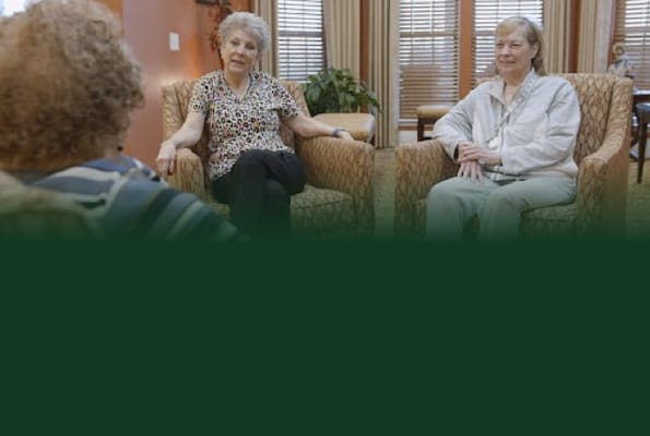 Two residents engaged in conversation in a lounge area