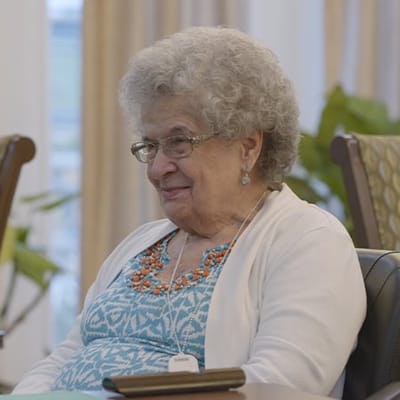 Smiling resident in a cozy indoor setting